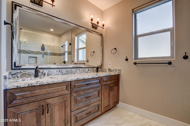 full bathroom featuring a shower stall, baseboards, double vanity, marble finish floor, and a sink