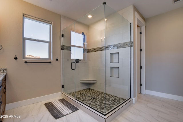 full bathroom with visible vents, a shower stall, vanity, and baseboards