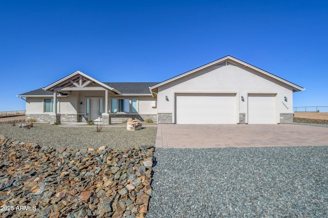 view of front of house featuring stone siding and stucco siding