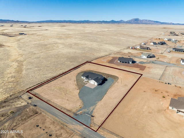 aerial view featuring view of desert and a mountain view