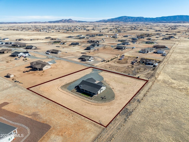 birds eye view of property featuring a mountain view