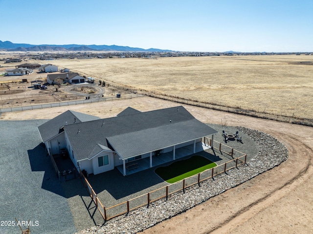 birds eye view of property with a mountain view and a rural view