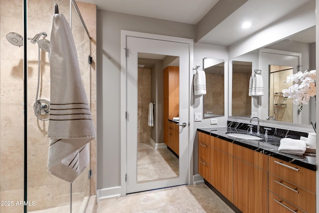 bathroom with tiled shower and vanity