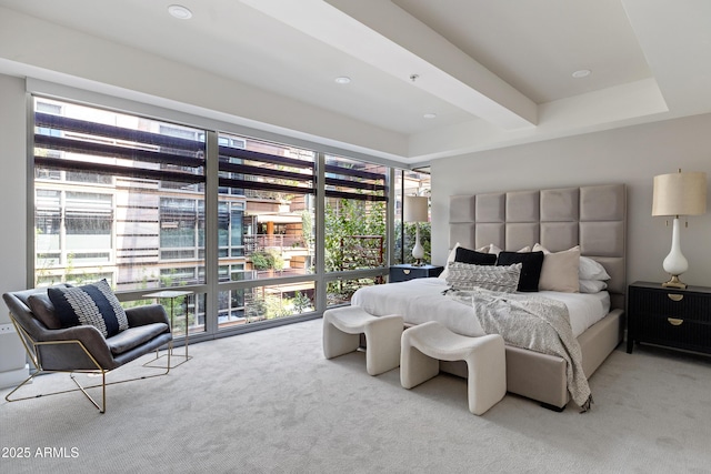 bedroom featuring beamed ceiling and light colored carpet