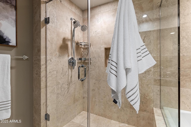 bathroom with a shower with door