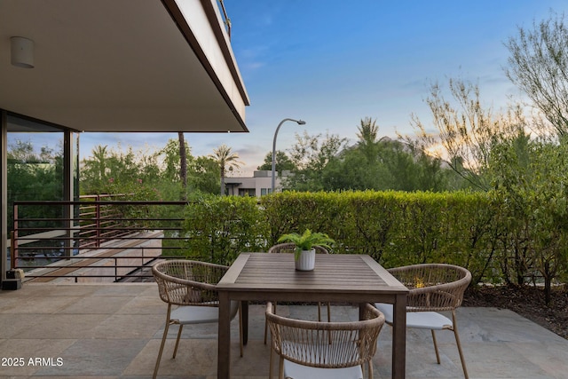 patio terrace at dusk with a balcony