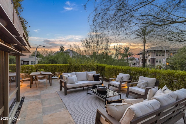 patio terrace at dusk featuring outdoor lounge area