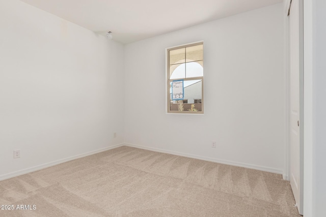 carpeted empty room with baseboards