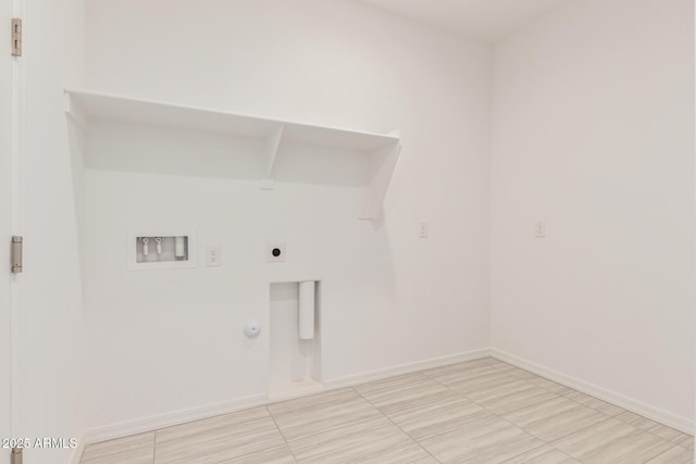 clothes washing area featuring baseboards, washer hookup, laundry area, hookup for a gas dryer, and hookup for an electric dryer