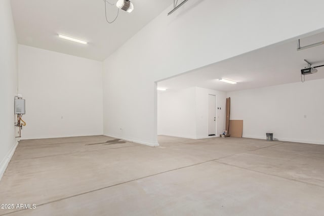 garage with a garage door opener and baseboards