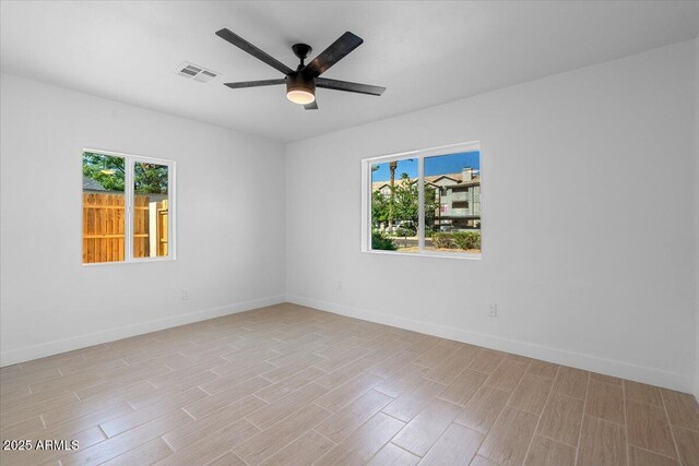 4400 N 20th St, Phoenix, AZ 85016 - empty room featuring plenty of natural light, light wood-style floors, and a ceiling fan