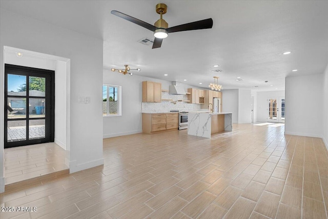 4400 N 20th St, Phoenix, AZ 85016 - unfurnished living room with a chandelier, healthy amount of natural light, ceiling fan, recessed lighting, and light wood-type flooring