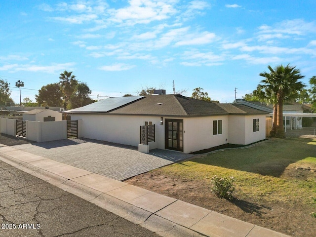 4400 N 20th St, Phoenix, AZ 85016 - ranch-style home featuring roof mounted solar panels, stucco siding, french doors, and a gate