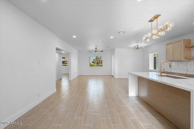 4400 N 20th St, Phoenix, AZ 85016 - kitchen with light brown cabinets, a chandelier, recessed lighting, backsplash, and light wood-style floors