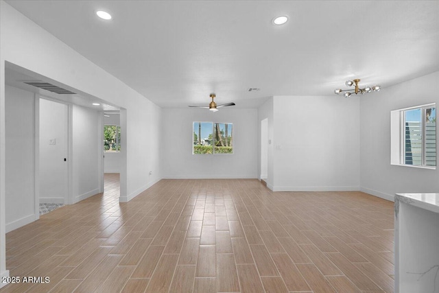 4400 N 20th St, Phoenix, AZ 85016 - unfurnished living room with healthy amount of natural light, light wood finished floors, recessed lighting, and a chandelier