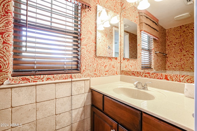 bathroom featuring a wealth of natural light and vanity