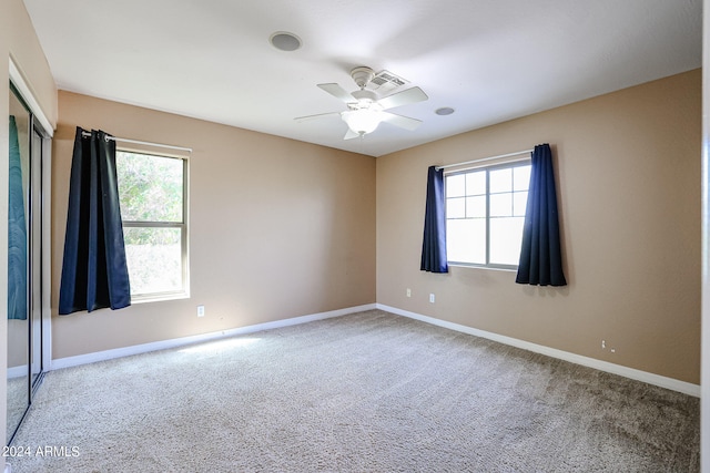 unfurnished room featuring ceiling fan and carpet floors