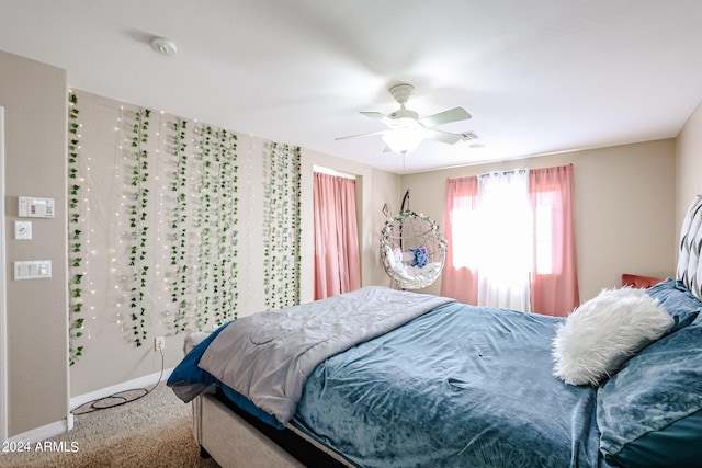 bedroom featuring ceiling fan and carpet