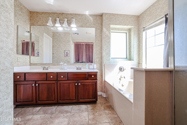 bathroom with a bath, tile patterned flooring, and vanity