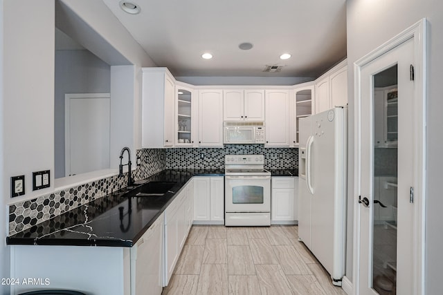 kitchen featuring white cabinetry, white appliances, sink, and tasteful backsplash