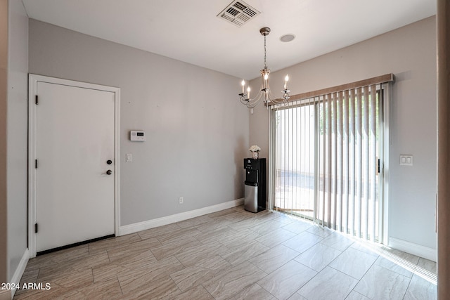 empty room featuring a notable chandelier