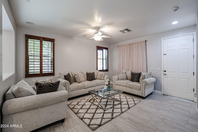 living room with ceiling fan and light hardwood / wood-style floors