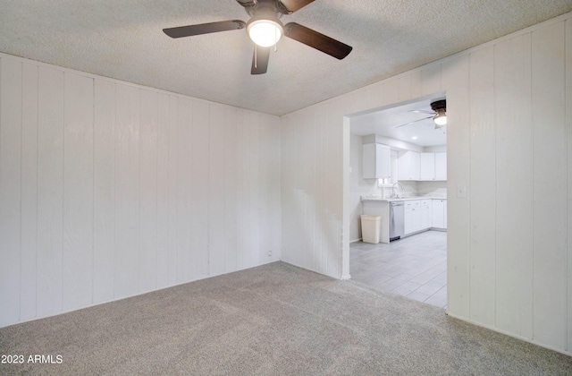 carpeted spare room with sink and a textured ceiling