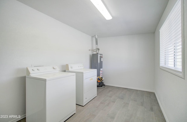 laundry room featuring light hardwood / wood-style flooring, gas water heater, and washer and dryer