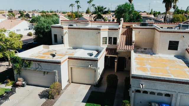 view of front facade with a garage and an outdoor kitchen