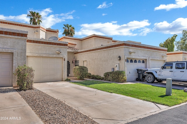 view of front facade featuring a front yard and a garage