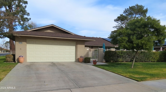 view of front of home featuring a garage and a front lawn