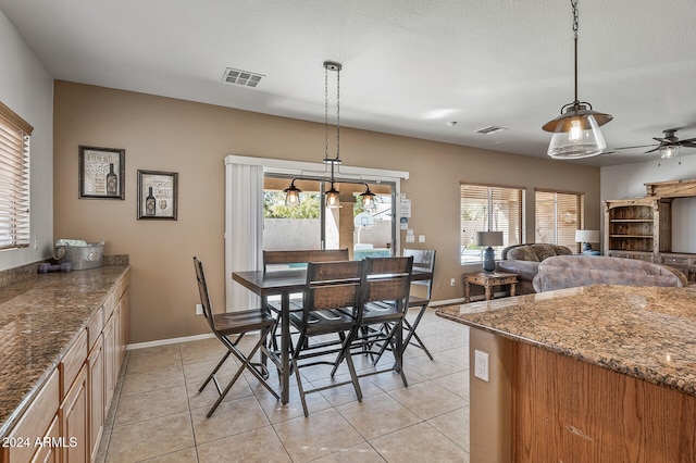 dining area featuring a wealth of natural light, ceiling fan, a textured ceiling, and light tile patterned floors