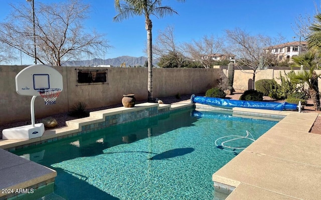 view of swimming pool with a mountain view