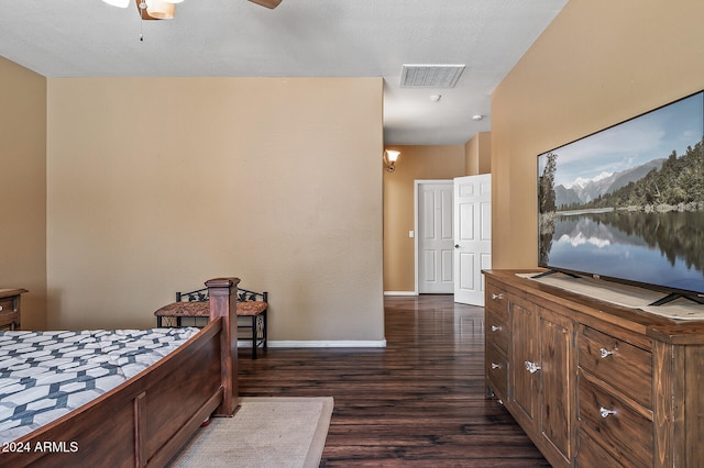 bedroom with ceiling fan, a textured ceiling, and dark hardwood / wood-style flooring