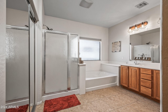 bathroom featuring vanity, shower with separate bathtub, and tile patterned floors