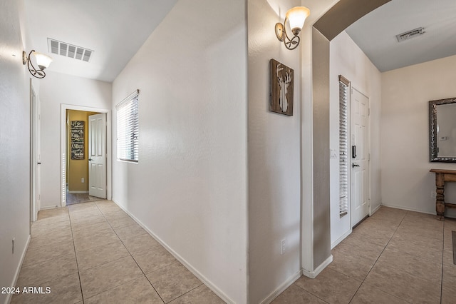 hall with light tile patterned floors