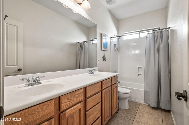 full bathroom with vanity, toilet, tile patterned floors, and shower / bath combo with shower curtain