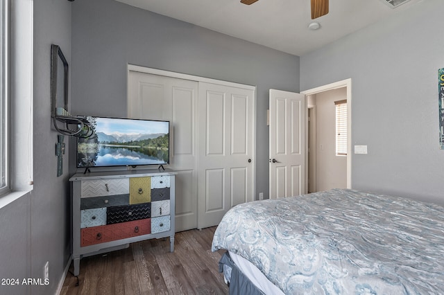 bedroom with a closet, hardwood / wood-style floors, and ceiling fan