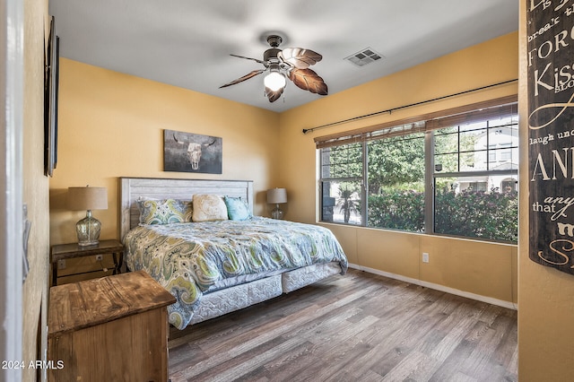 bedroom with wood-type flooring and ceiling fan