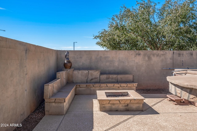 view of patio / terrace with an outdoor fire pit