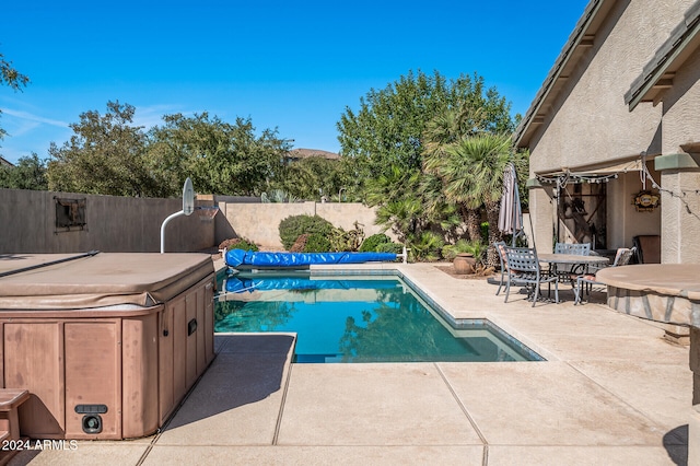 view of pool featuring a hot tub and a patio area