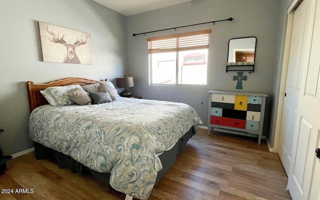 bedroom with hardwood / wood-style flooring and a closet