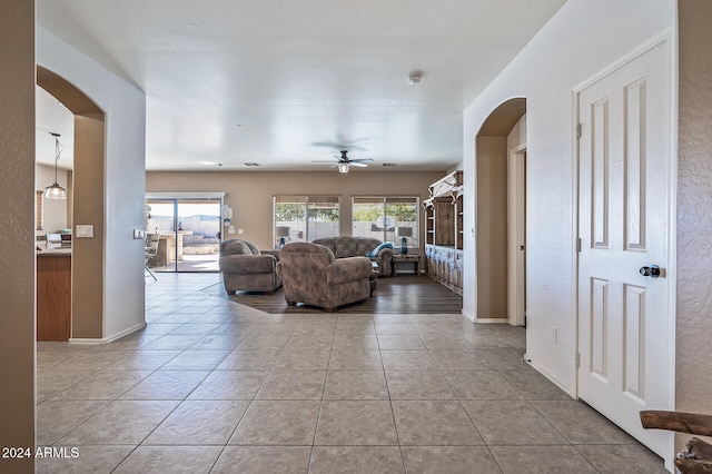 living room with ceiling fan and light tile patterned floors