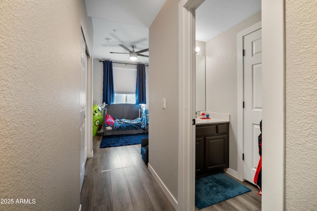 corridor with hardwood / wood-style floors