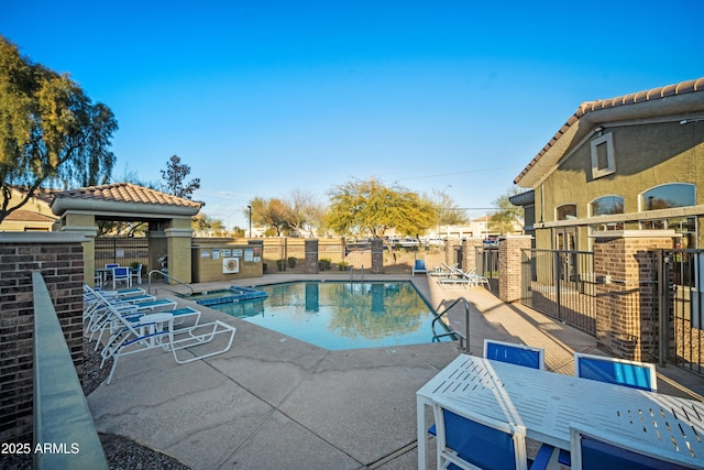 view of pool featuring a patio area and a community hot tub