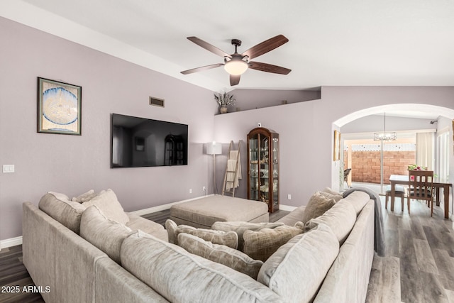 living room featuring ceiling fan with notable chandelier, wood-type flooring, and lofted ceiling