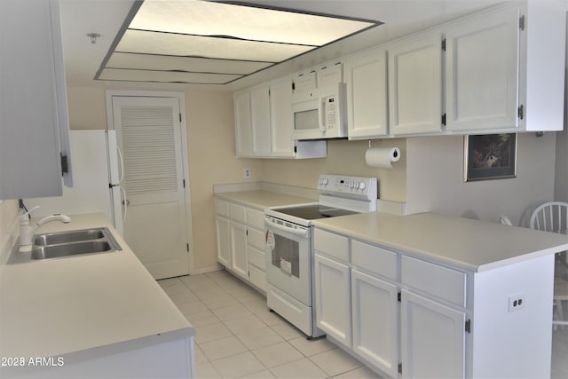 kitchen with white appliances, white cabinets, a sink, and light countertops