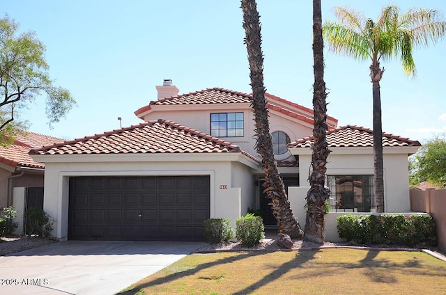 mediterranean / spanish house with a garage and a front yard