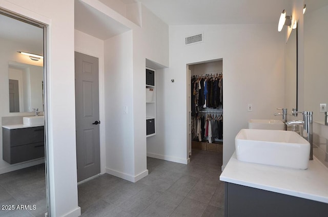 bathroom with vaulted ceiling and vanity