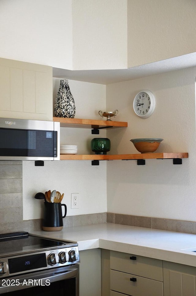 kitchen with gray cabinets and appliances with stainless steel finishes